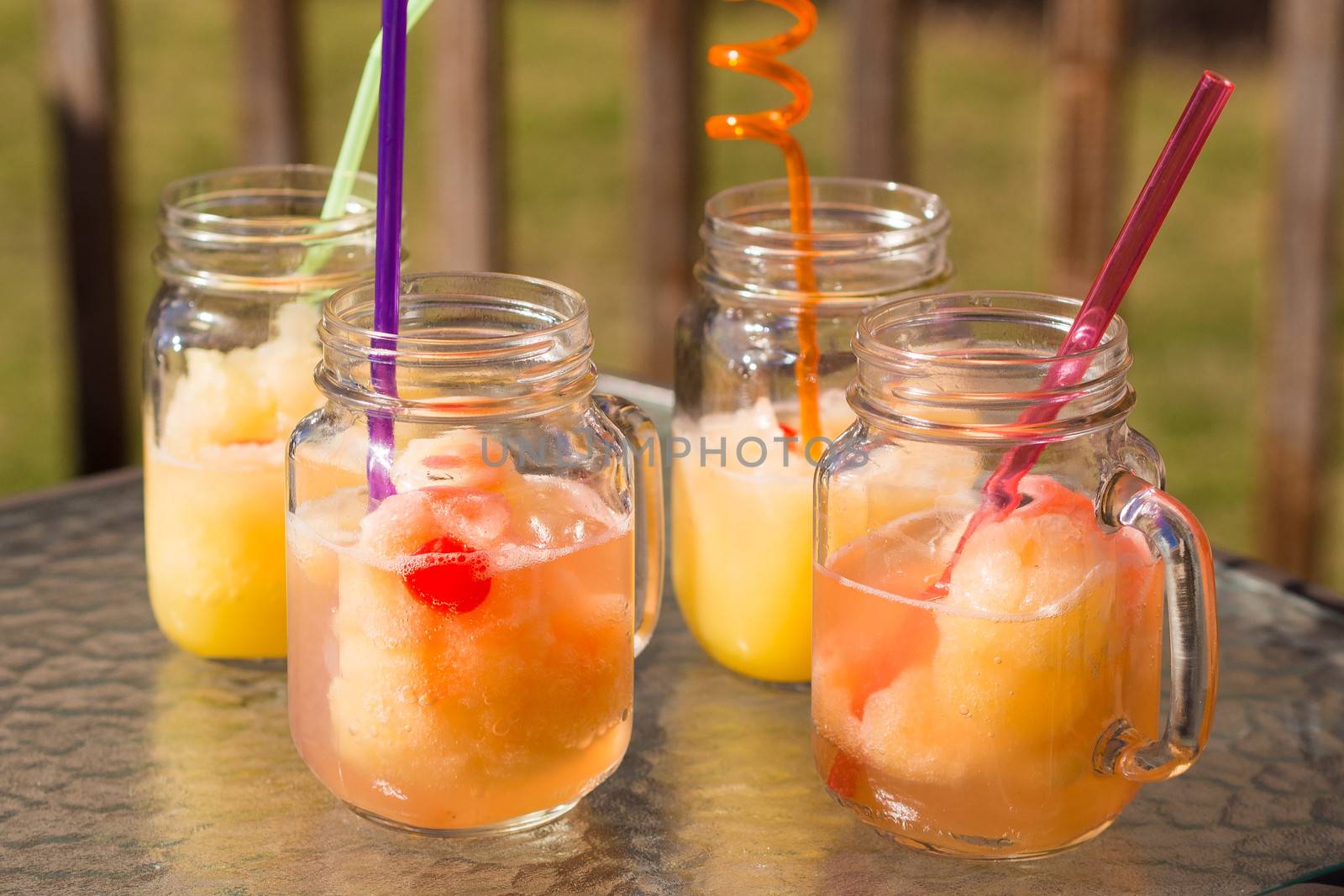 Homemade fruits slush in a jar with a straw