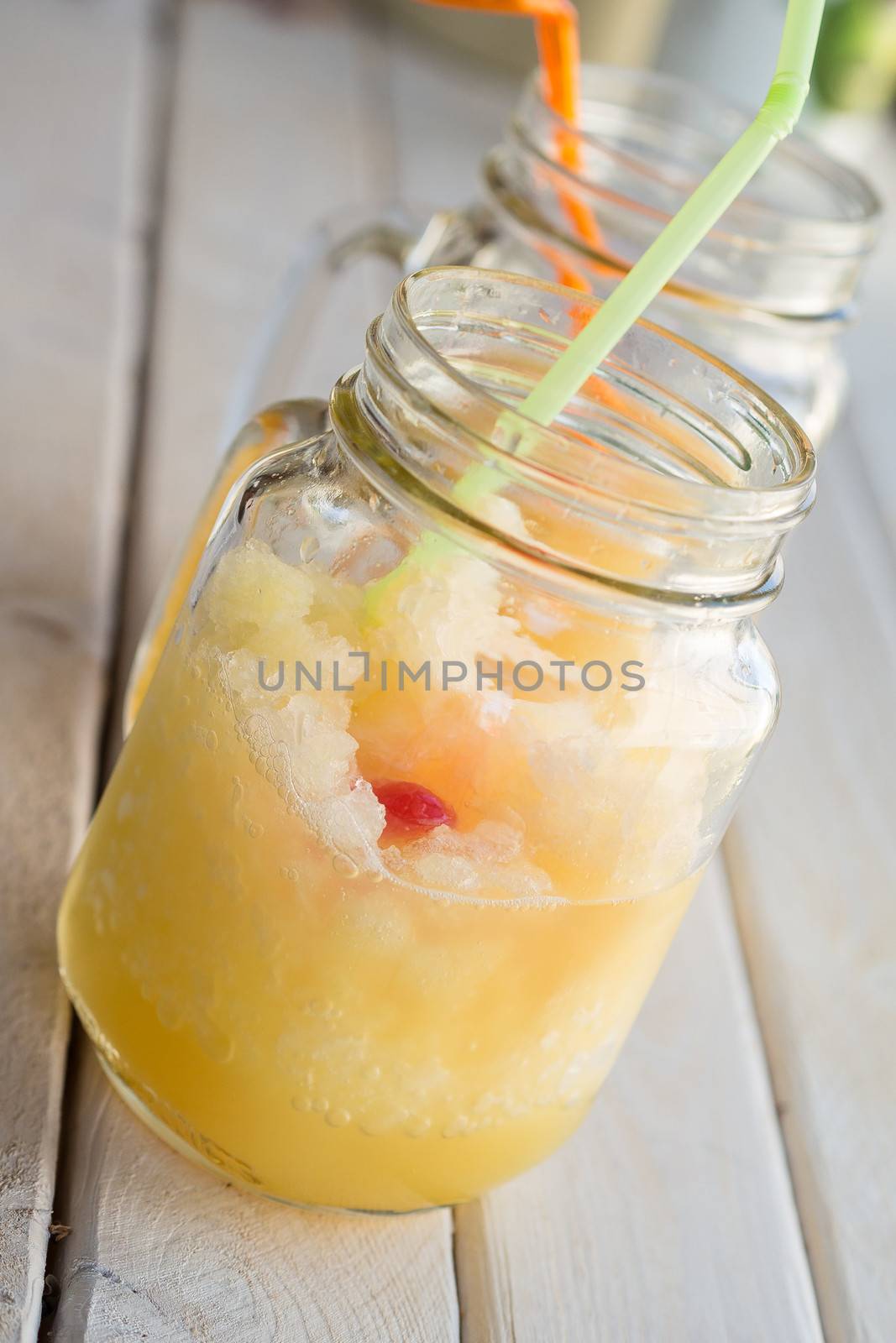 Homemade fruits slush in a jar with a straw