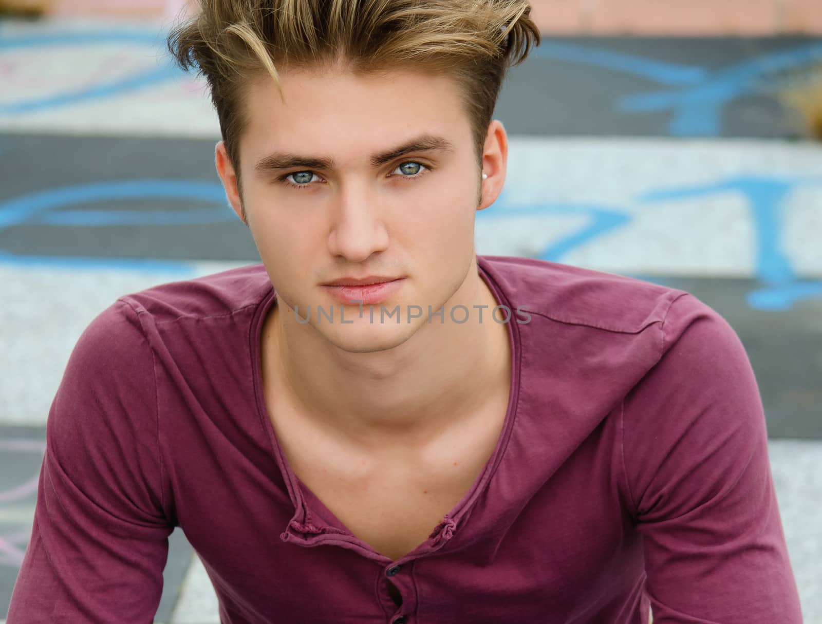 Handsome blond young man, blue eyes, looking at camera by artofphoto