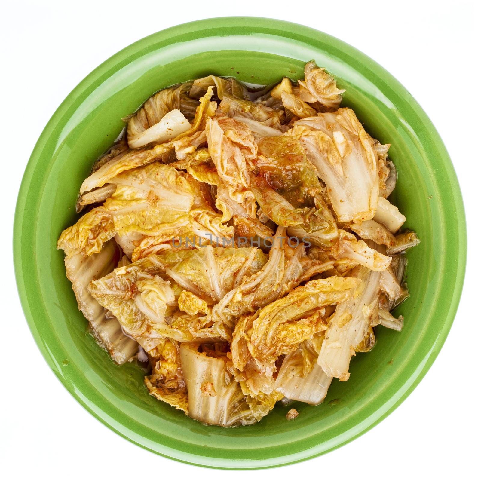 fermented napa cabbage with garlic and onion - a tradition Korean kimchi dish in a small ceramic bowl, isolated on white