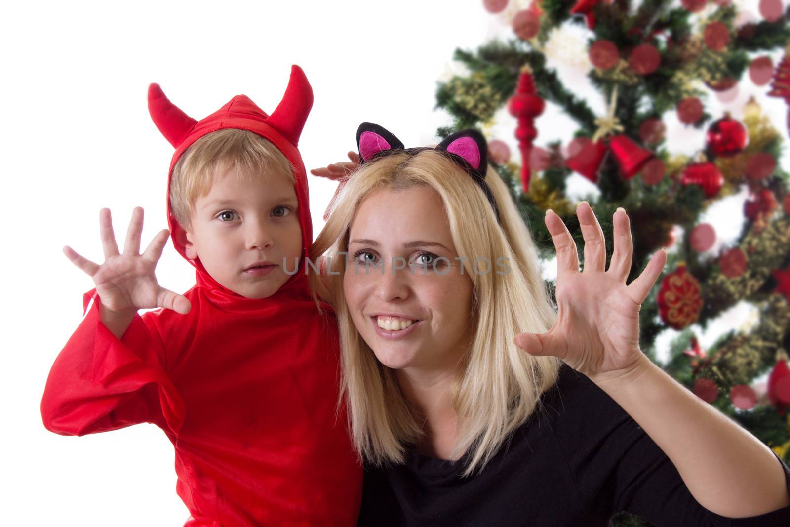 Mother and son in deuce costumes under Christmas tree by Angel_a
