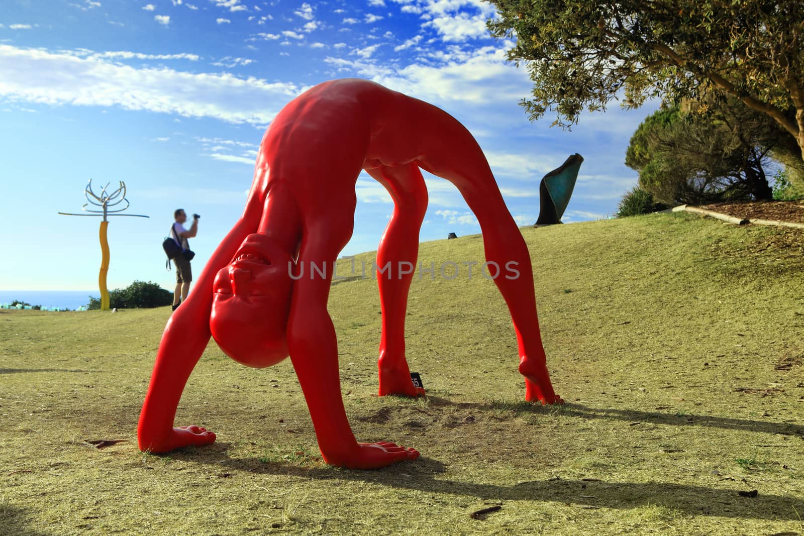 Bondi, Australia - November 3,  2013: Sculpture By The Sea, Bondi 2013. Annual cultural event that showcases emerging artists from around the world  Sculpture titled 'Rainbow' by chen Wenling (China).  Medium -  bronze, automotive paint.  Price $175000