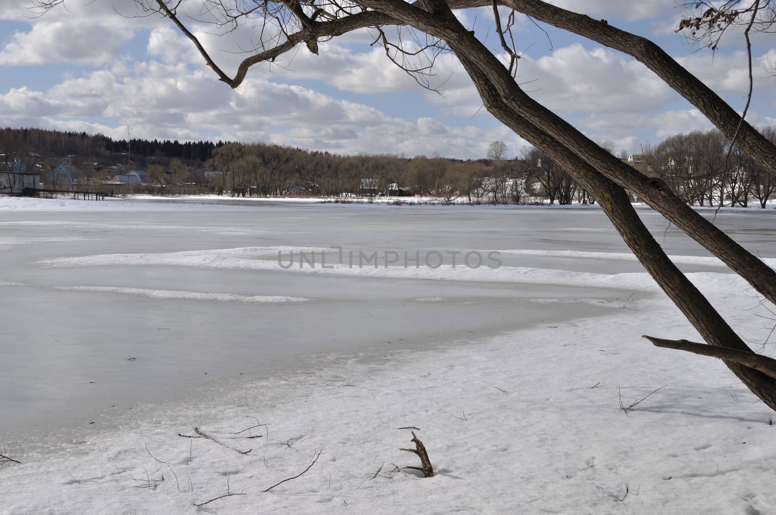 Spring landscape with melting ice on a lake