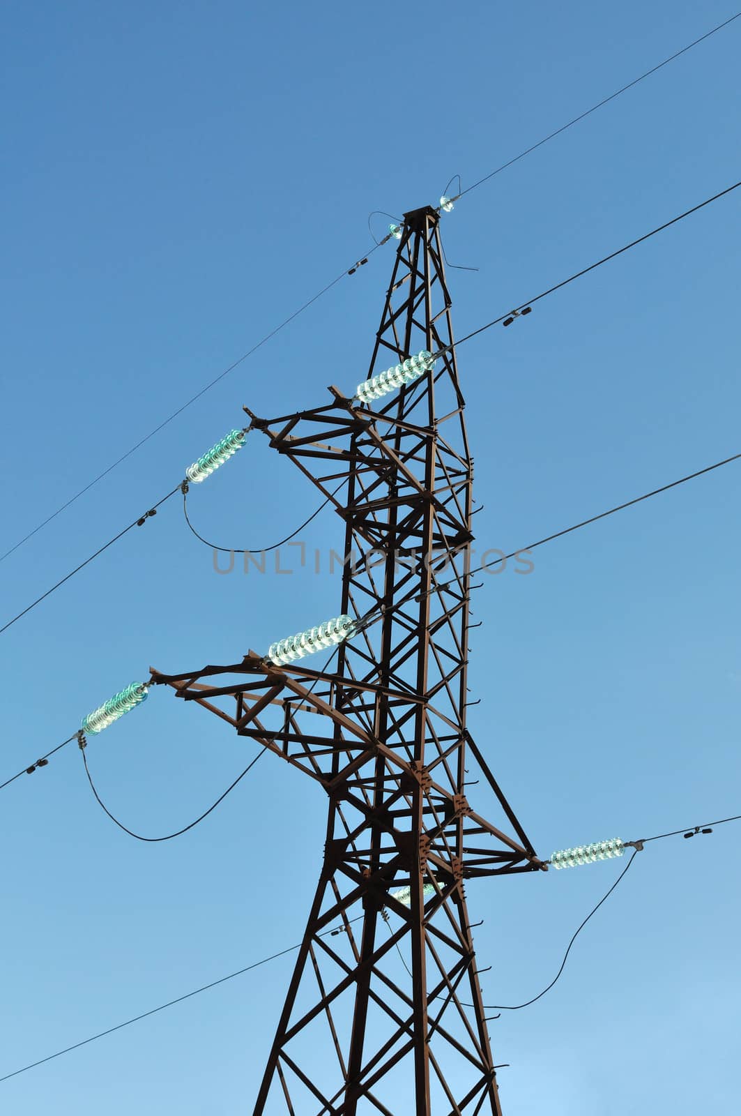 Mast of high voltage electric line on blue sky background