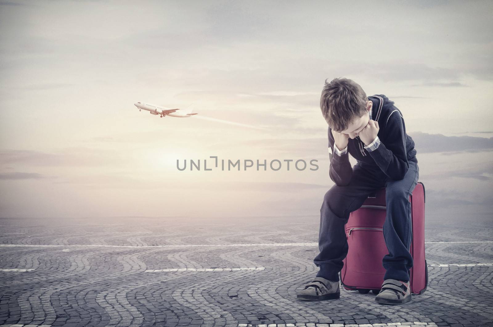 Upsaid boy sitting on baggagebecause he losing the plane