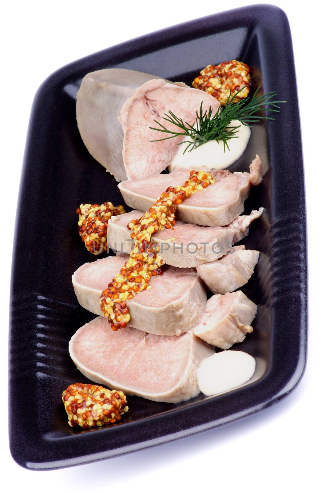 Slices of Delicious Boiled Beef Tongue with Whole Grain Mustard, Horseradish and Dill on Black Plate isolated on white background