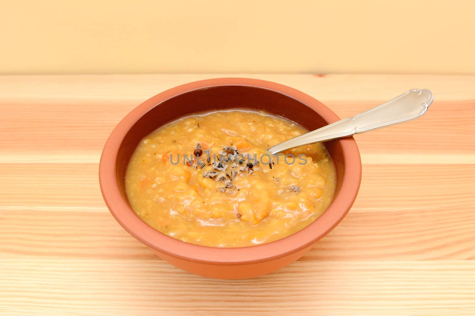 Bowl of hearty lentil and vegetable soup with extra seasoning