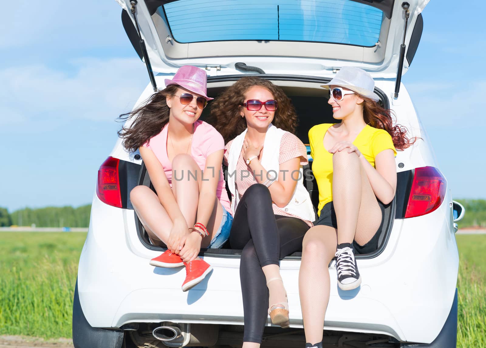 young attractive woman sitting in the open trunk by adam121
