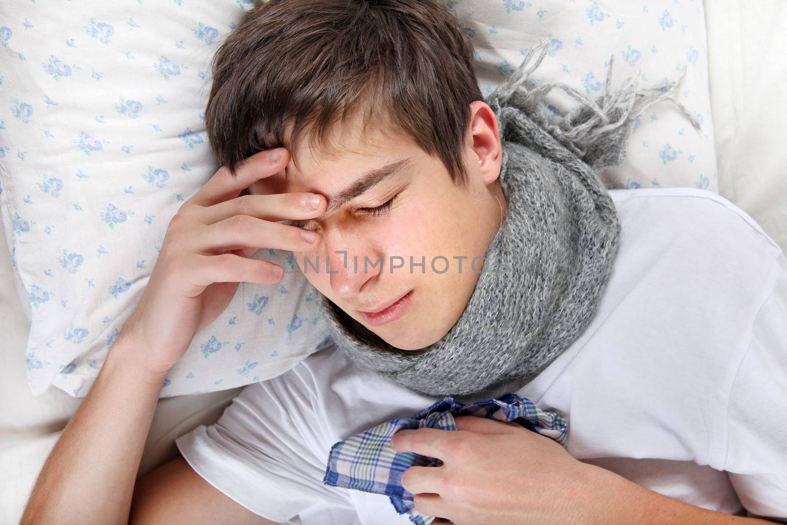 Sick Young Man feels Headache and lying on the Bed