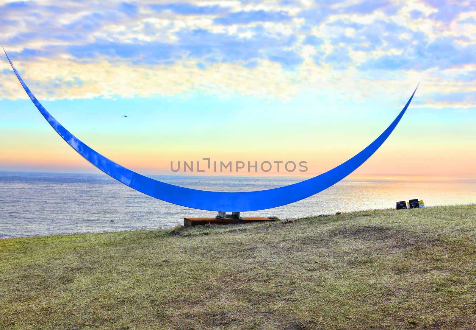 Bondi, Australia - November 3,  2013: Sculpture By The Sea, Bondi 2013. Annual cultural event that showcases emerging artists from around the world  Sculpture titled 'The Cheshire's Grin' by Matthew Harding (VIC).  Medium stainless steel, harcourt granite base.  Price $35000