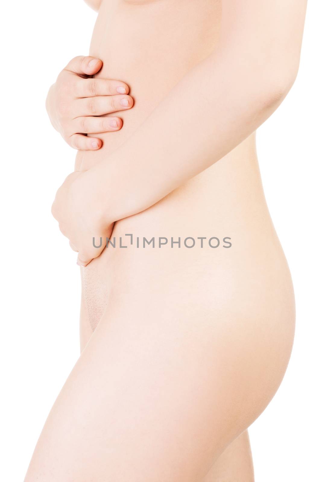 Female sexy naked body. Side view.Touching her belly. Isolated on white.