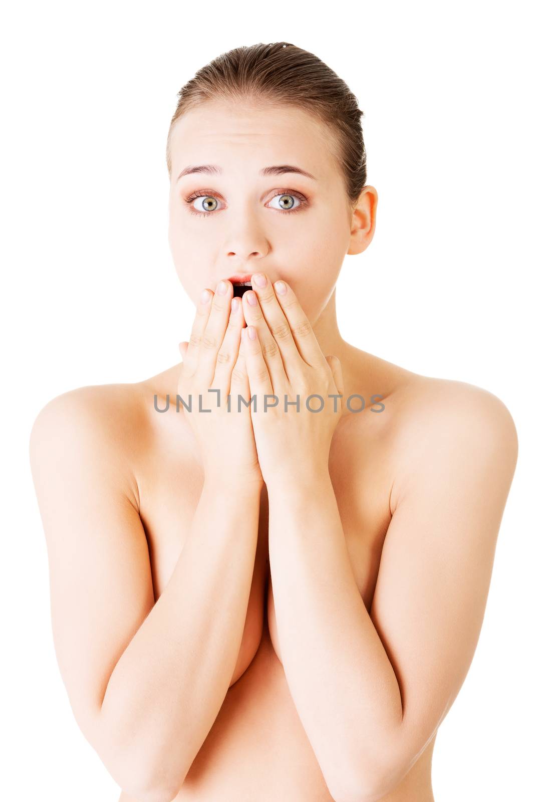 Attractive young naked woman expresses a shock. Isolated on white.