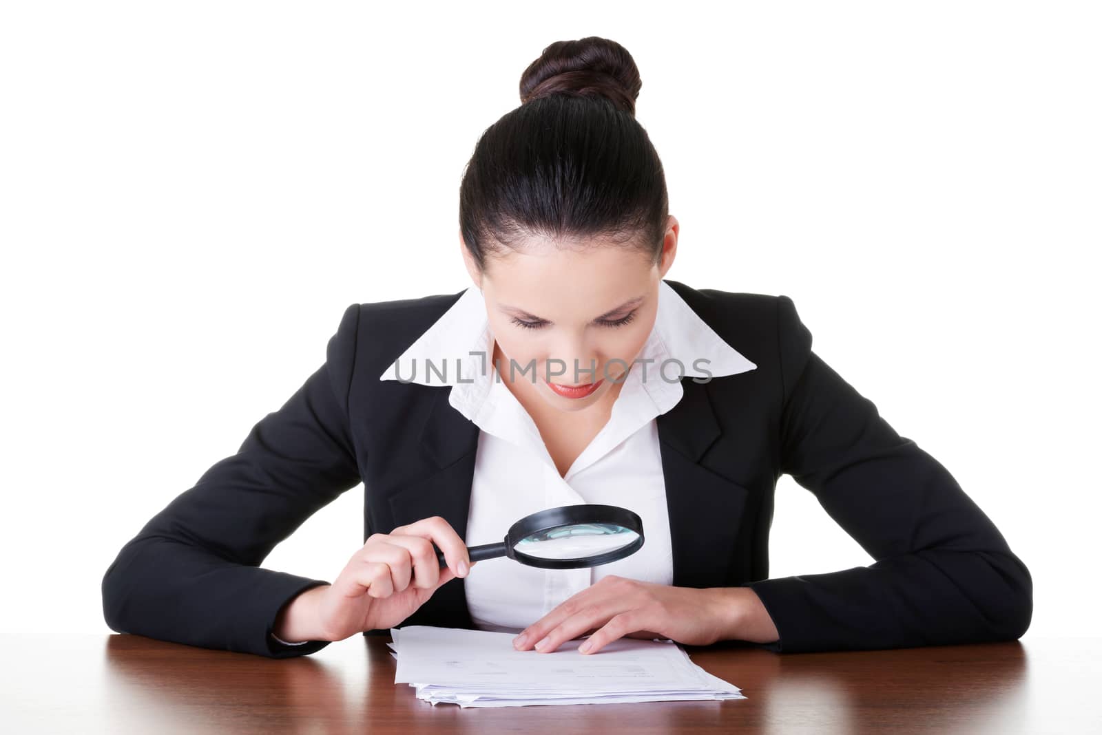 Business woman reading though magifying glass. Isolated on white.