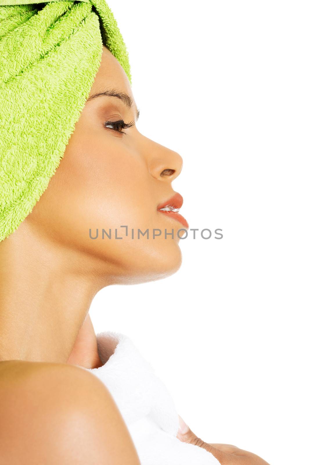 Profile of attractive woman wrapped in towel with turban. Isolated on white.