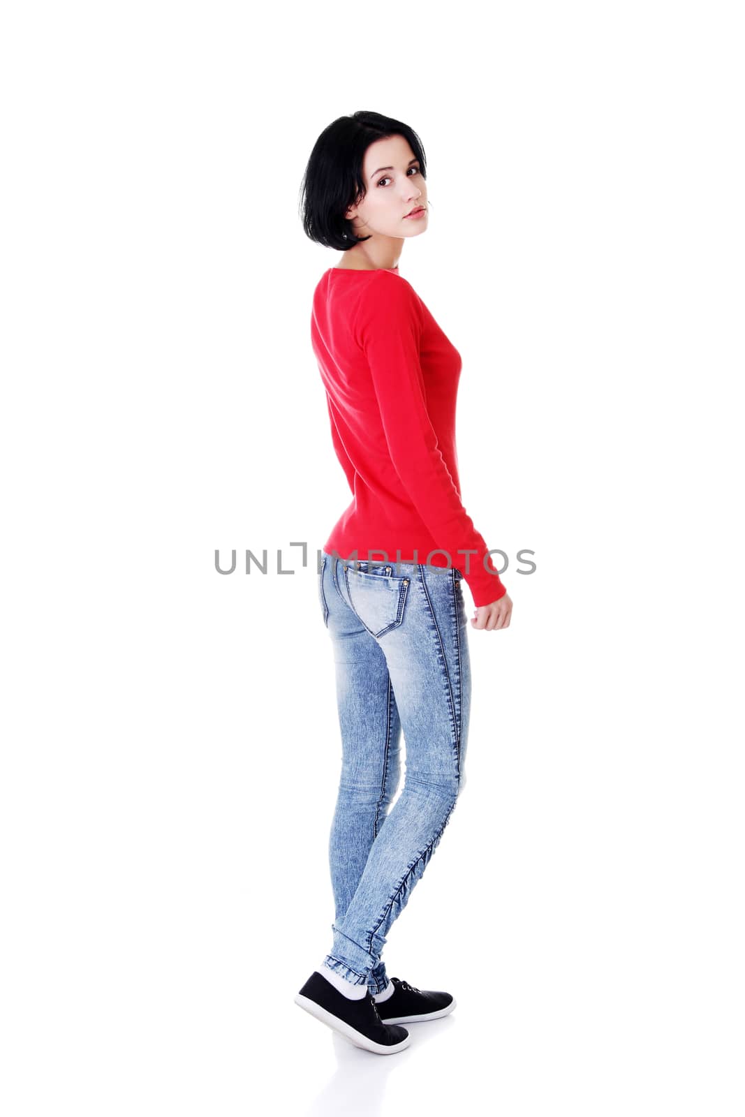 Attractive woman in red tshirt. Side view. Isolated on white.