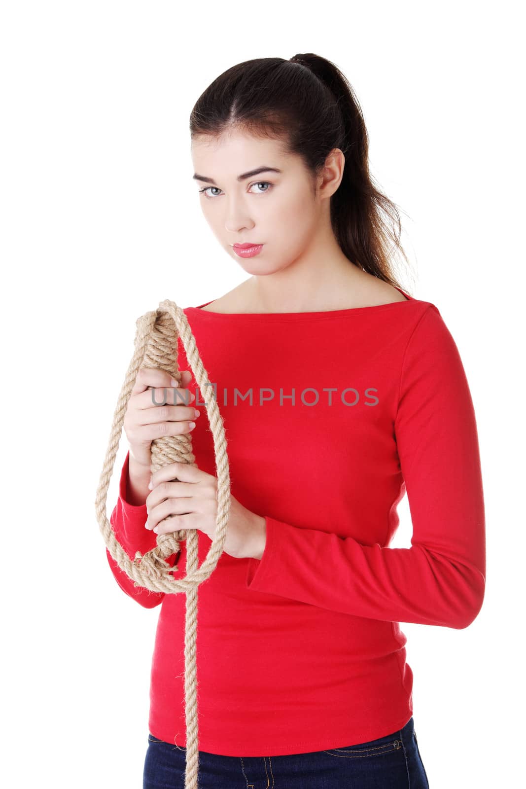 Happy casual woman holding a rope. Isolated on white.
