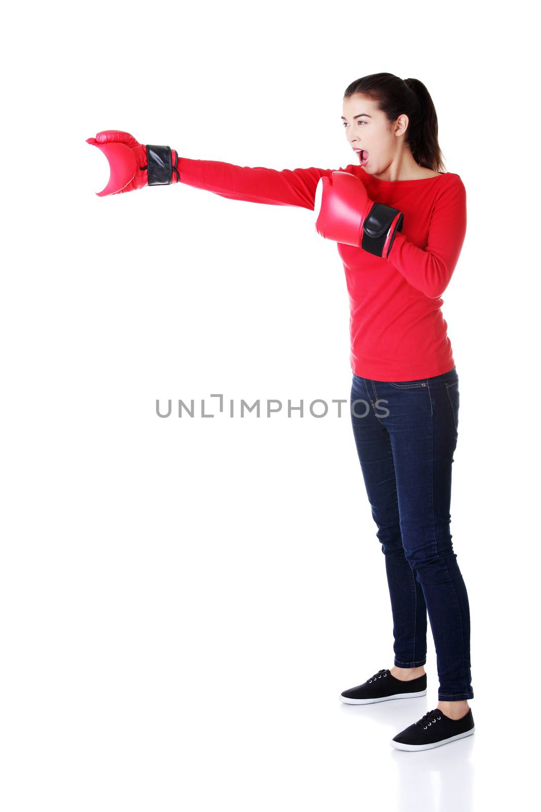 Happy casual woman with boxing gloves. Isolated on white.