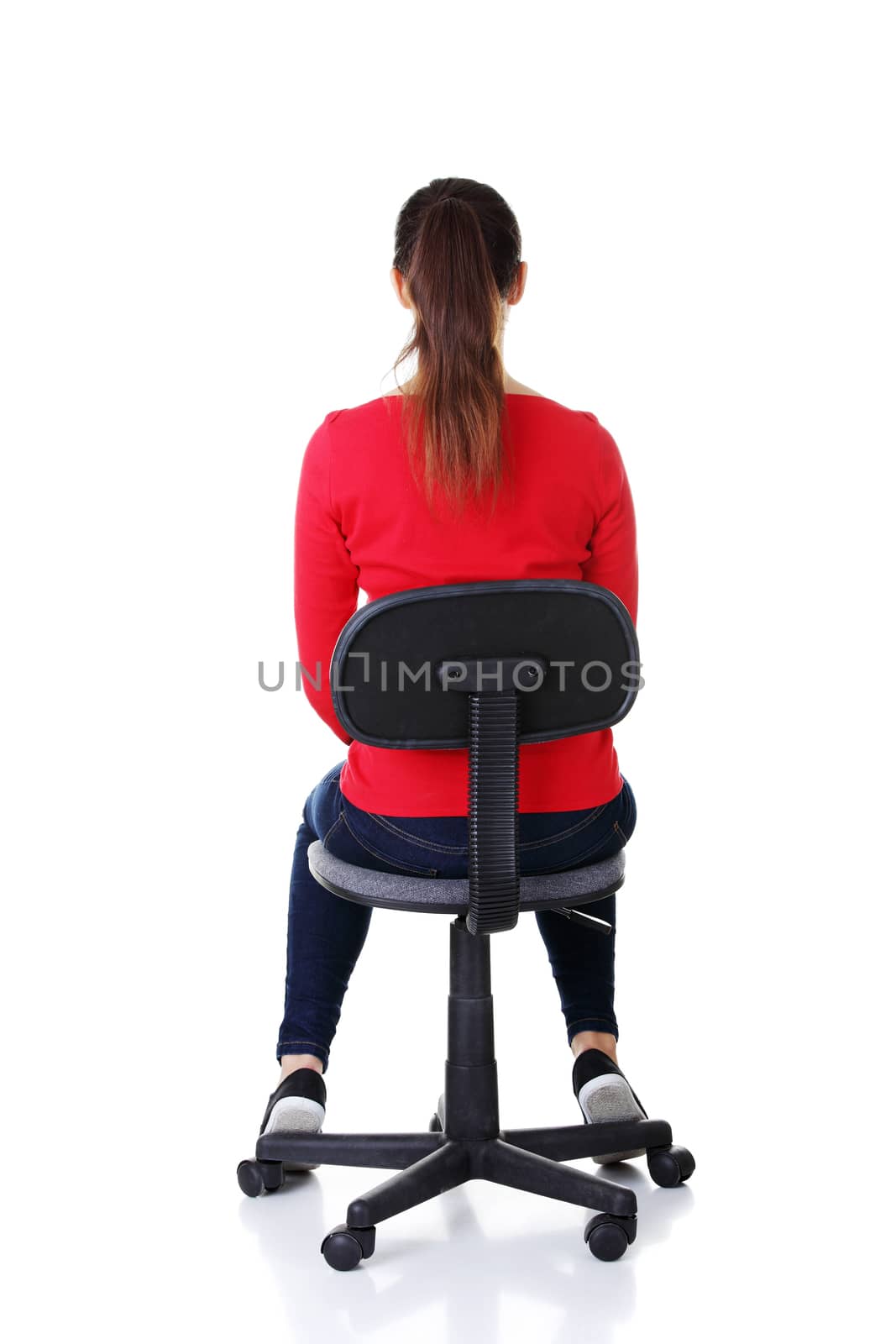 Happy casual woman sitting on a chair. Back view. by BDS