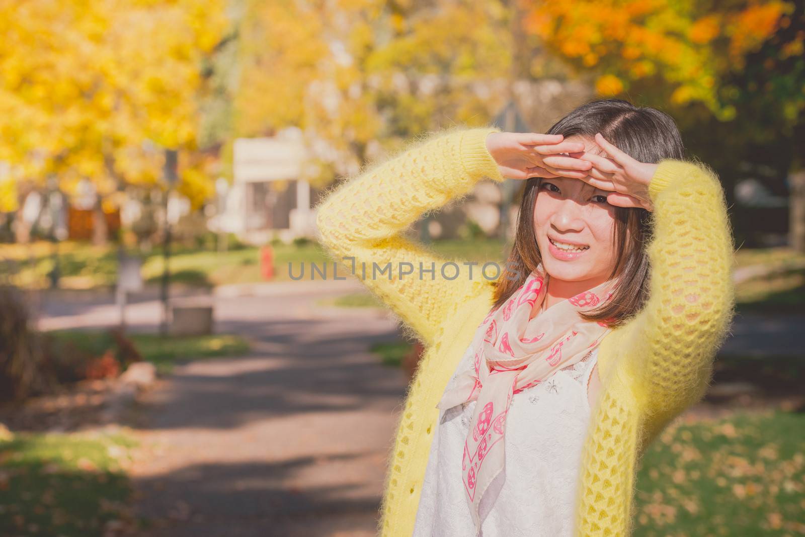 Woman shielding herself from the sun by IVYPHOTOS