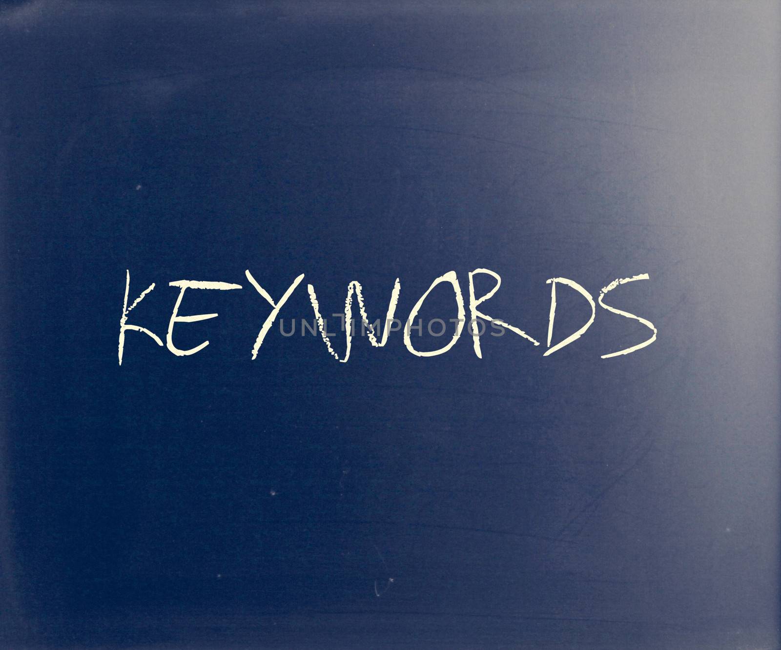 The word "Keywords" handwritten with white chalk on a blackboard by nenov