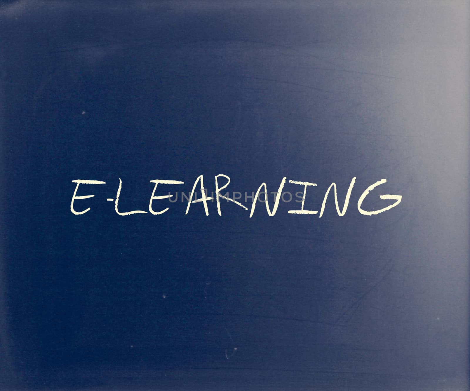 "E-learning" handwritten with white chalk on a blackboard.
