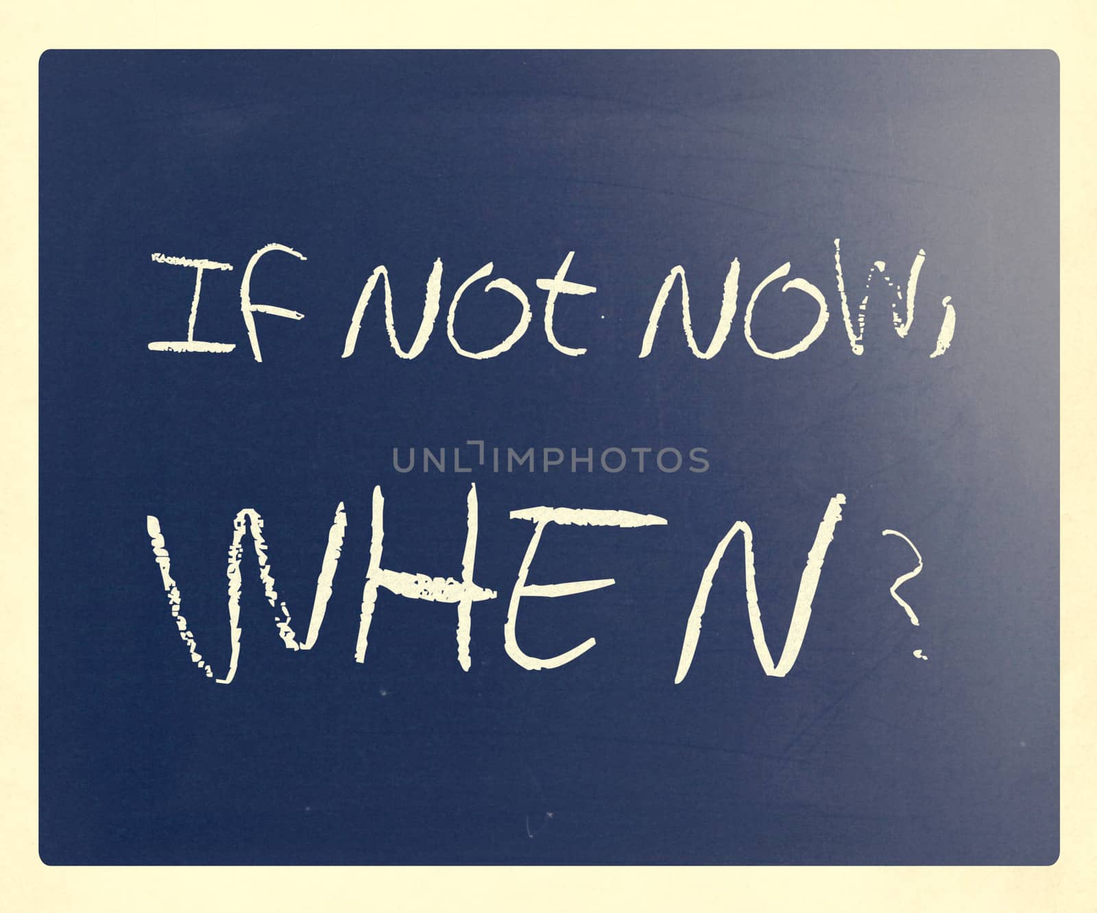 "If not now, when?" handwritten with white chalk on a blackboard.