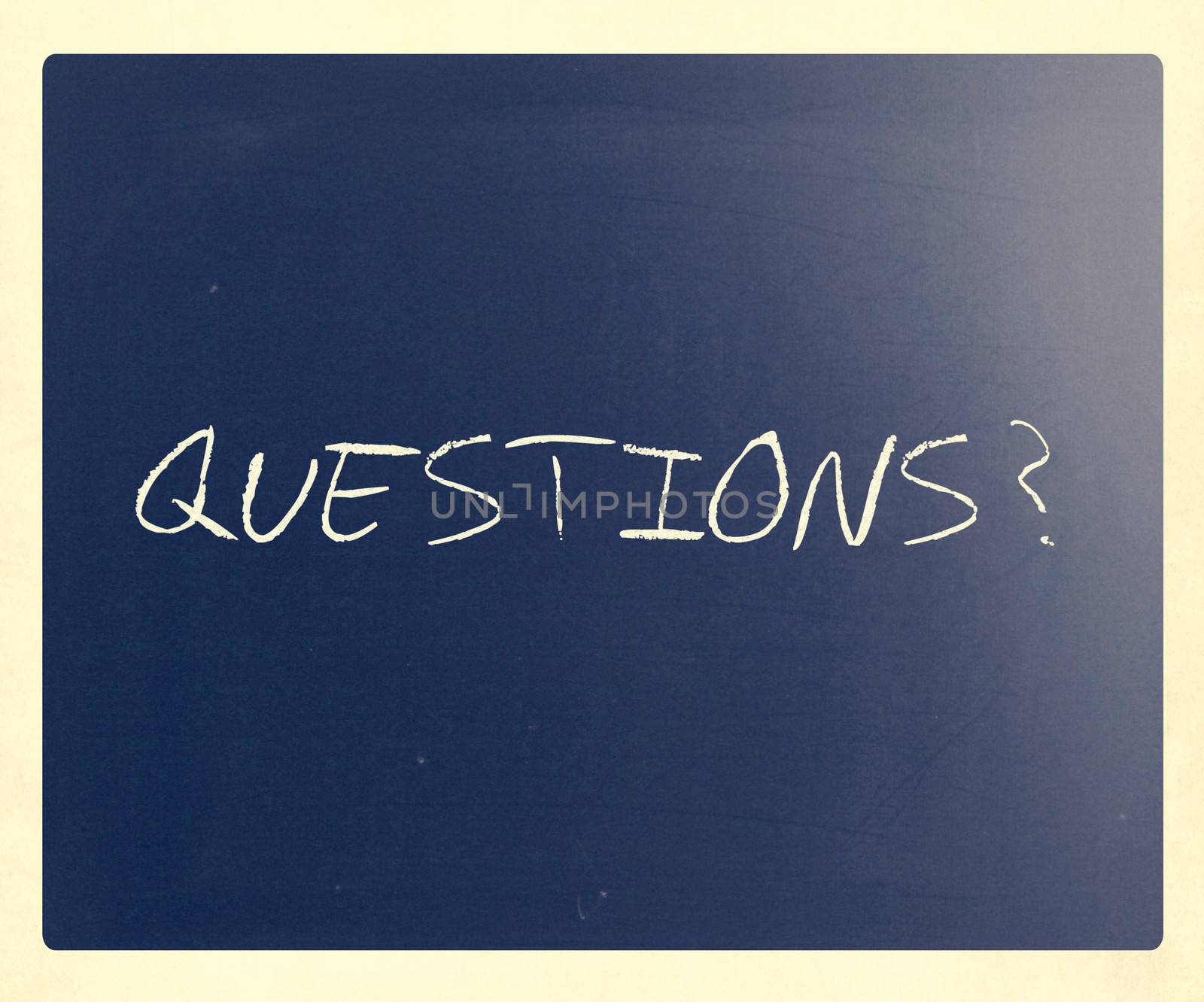 "Questions?" handwritten with white chalk on a blackboard by nenov