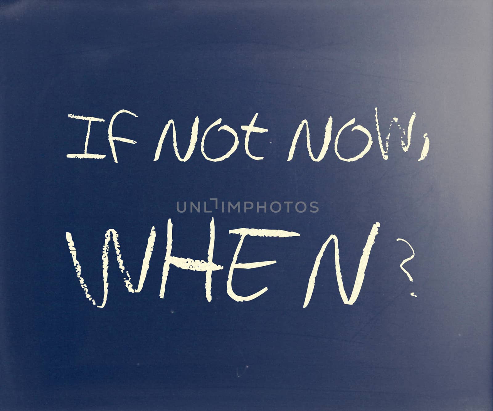 "If not now, when?" handwritten with white chalk on a blackboard.