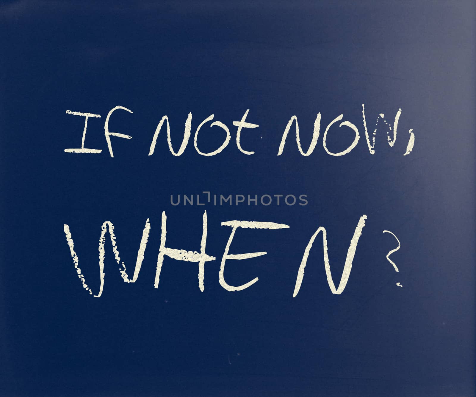 "If not now, when?" handwritten with white chalk on a blackboard.