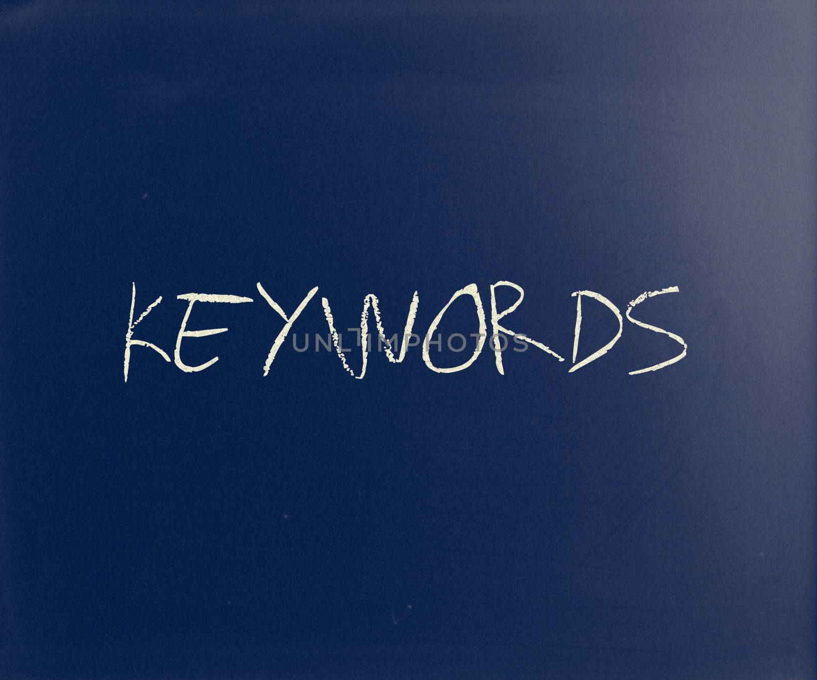 The word "Keywords" handwritten with white chalk on a blackboard by nenov