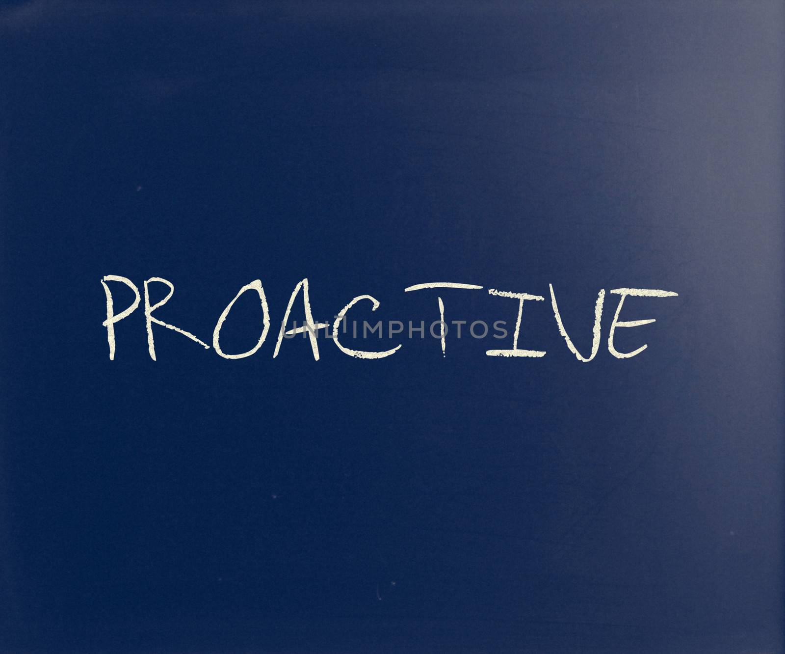 The word 'Proactive' handwritten with white chalk on a blackboard.