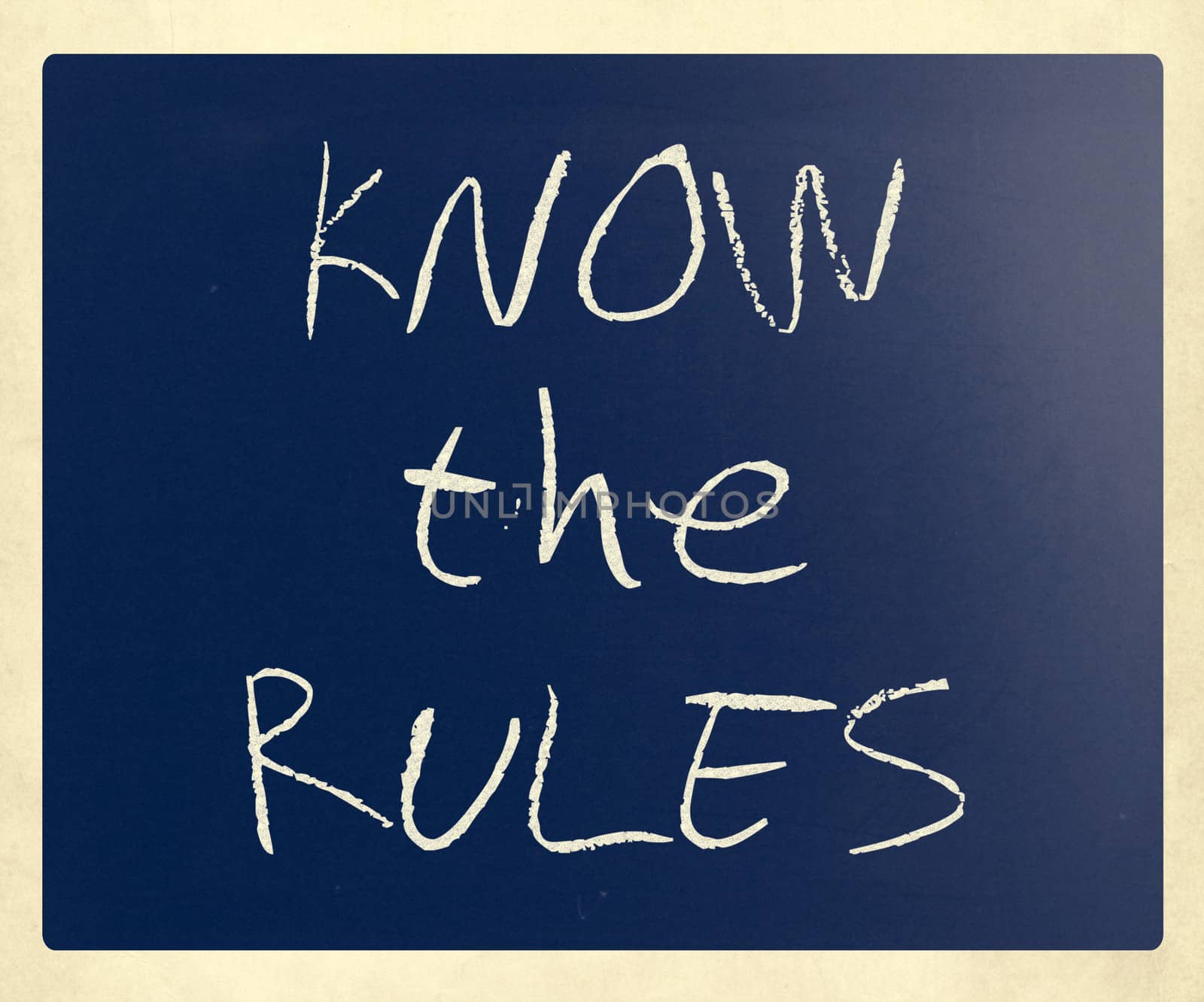 "Know the rules" handwritten with white chalk on a blackboard.