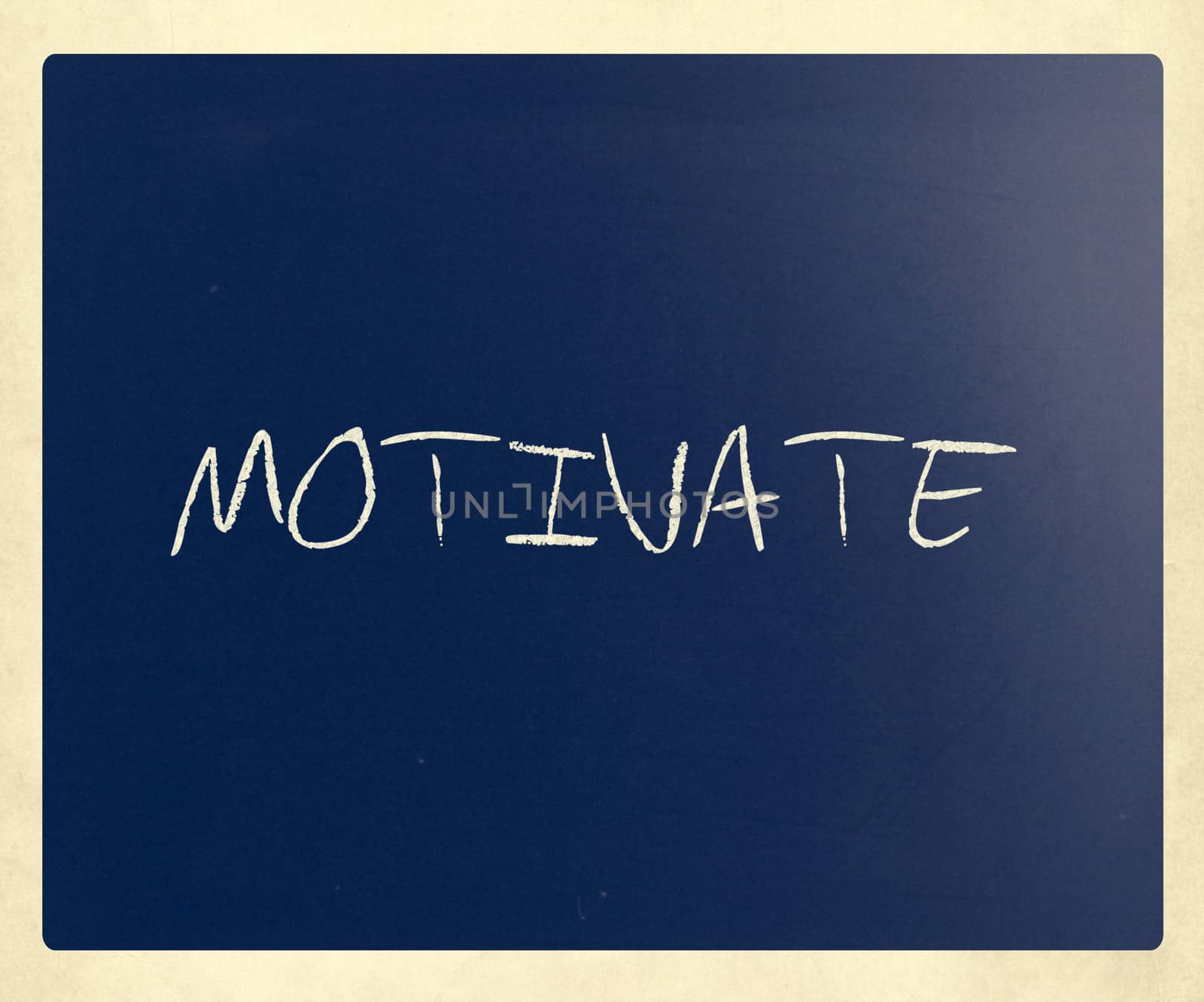 "Motivate" handwritten with white chalk on a blackboard.