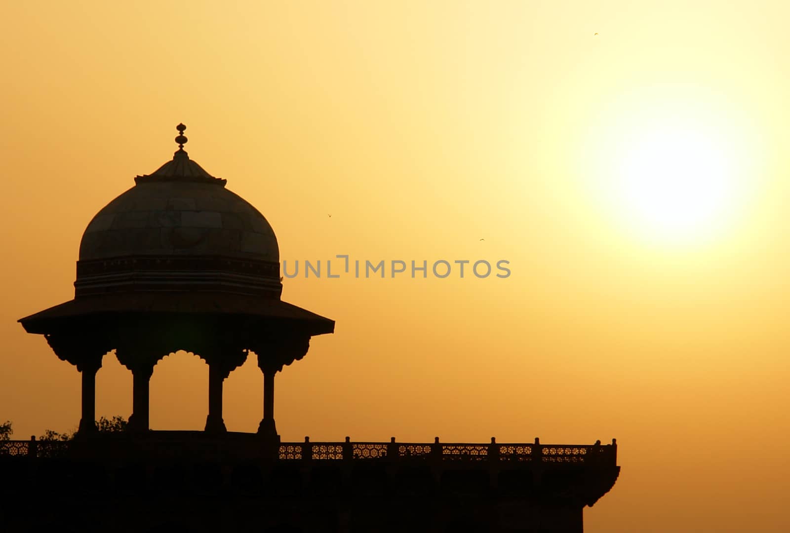 Moslem fortress silhouette at sunrise. Taj Mahal, Agra, India
