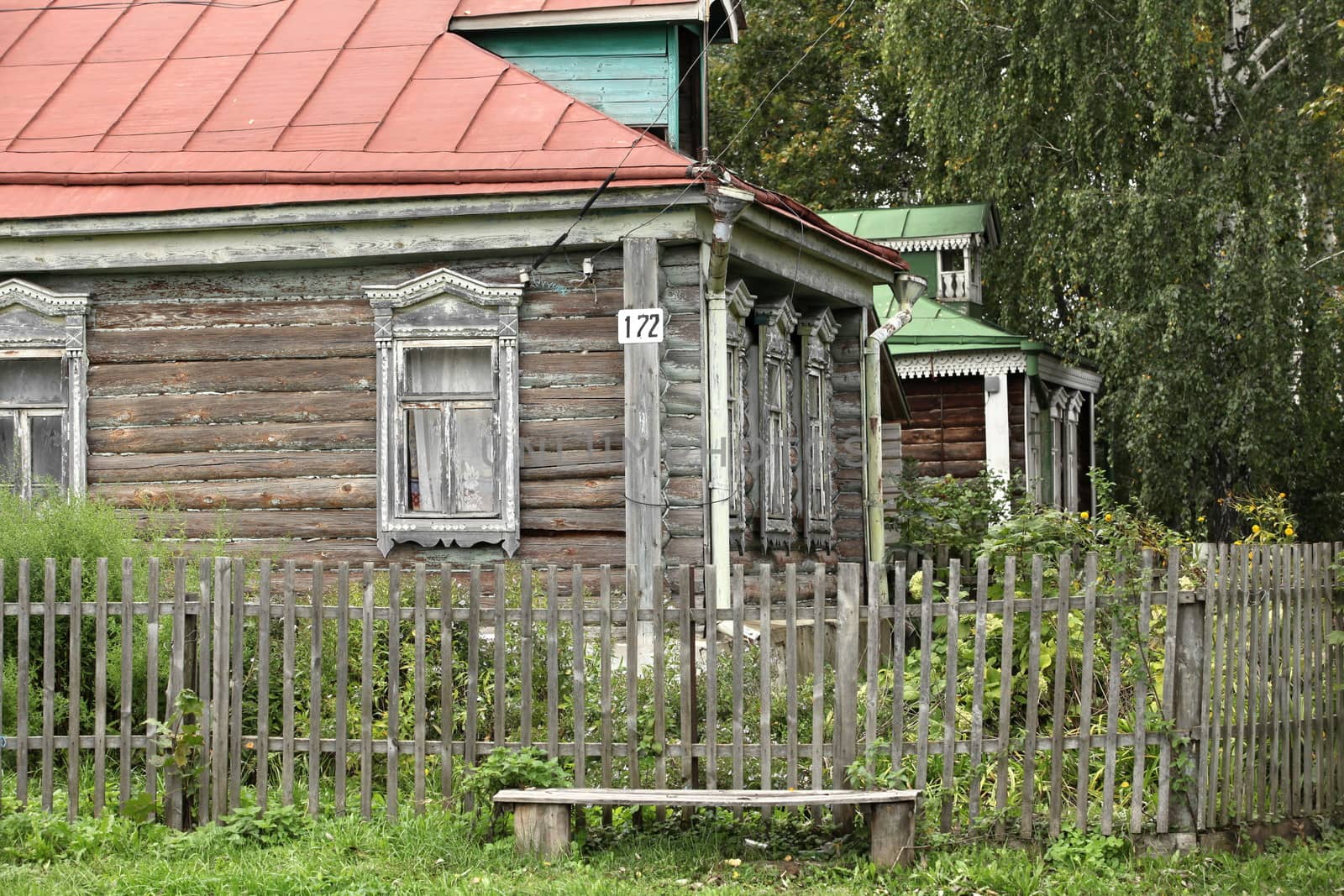 View of the old a log house with with garden
