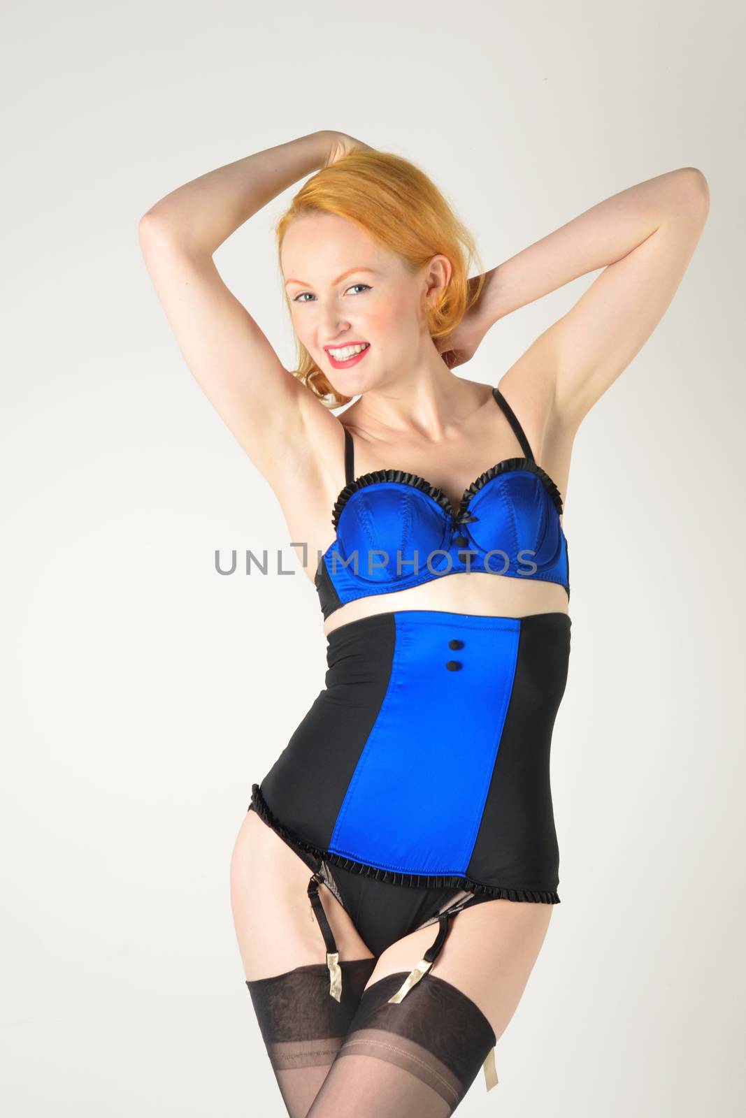 Retro model in blue underwear with arms raised