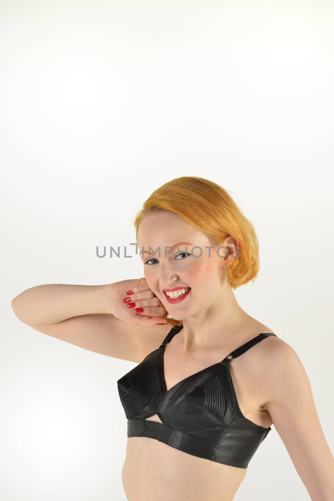 Cheeky red head in retro black bra