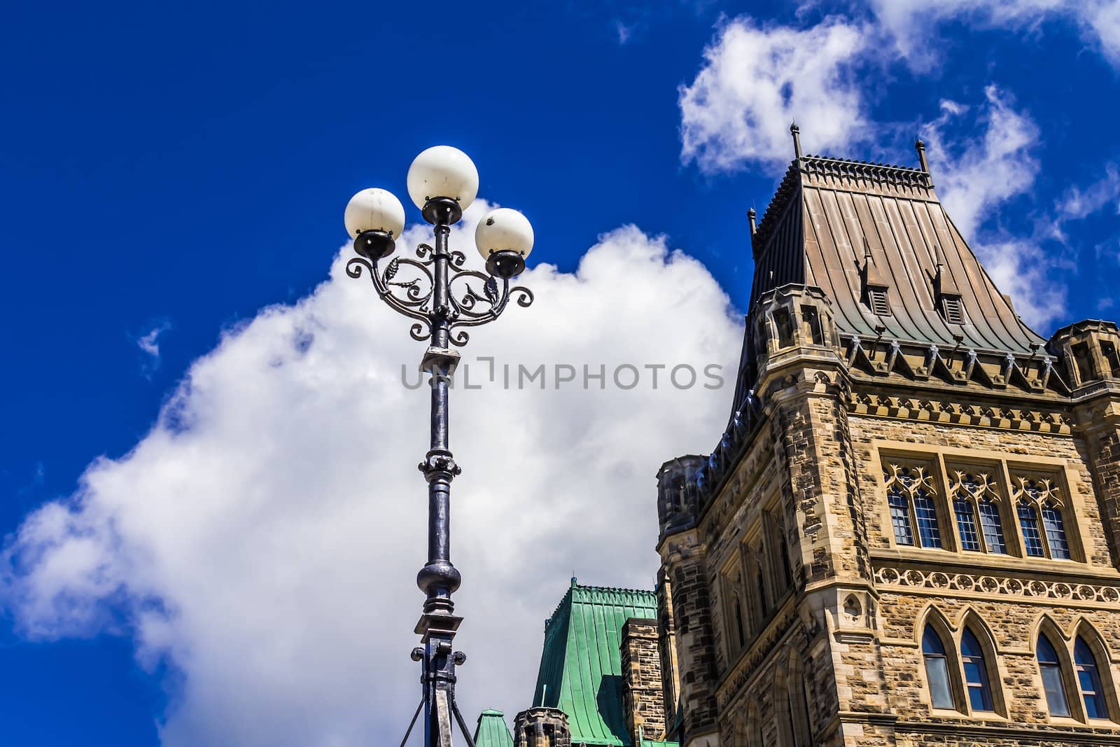 A lamp in beside the Parliament building on Parliament hill in Ottawa, Ontario, Canadastructure; street light; sky; parliament hill