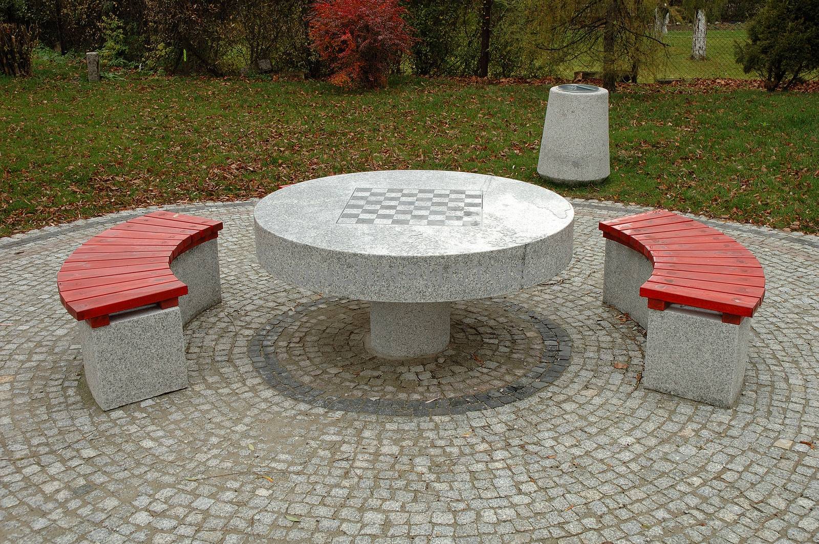 Benches and chess table in park by janhetman