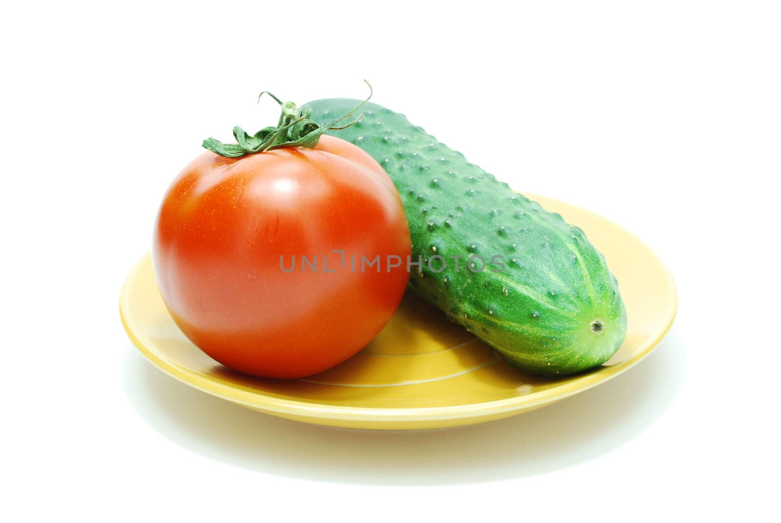Red Tomato and Green Cucumber on Plate on White Backgrund