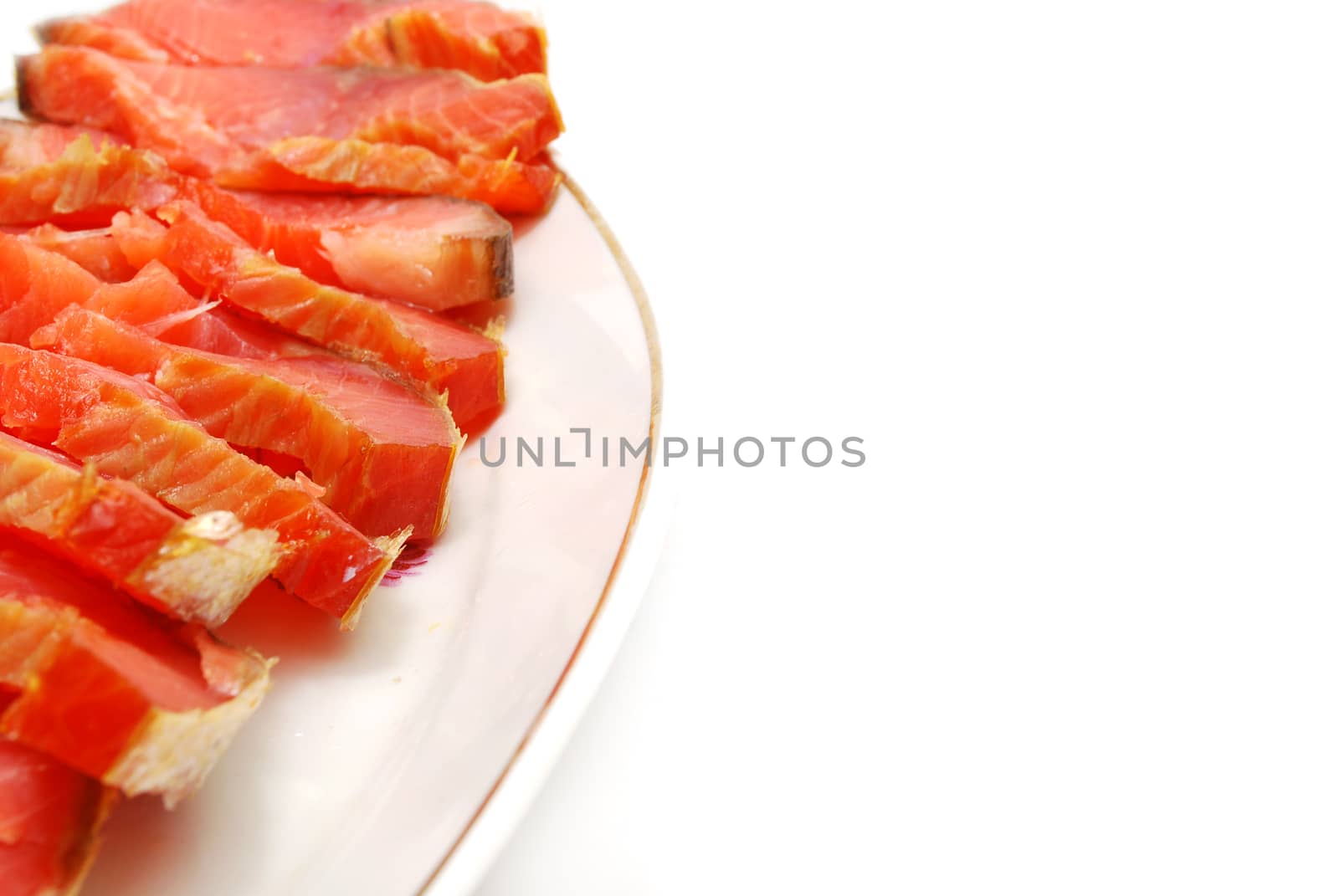 Dish of Pieces of Red Fish Slices Closeup to Ornate Corner (to use as Background)