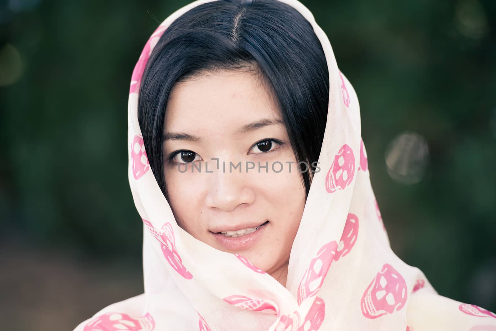 Detailed portrait of beautiful young woman with skull covering head