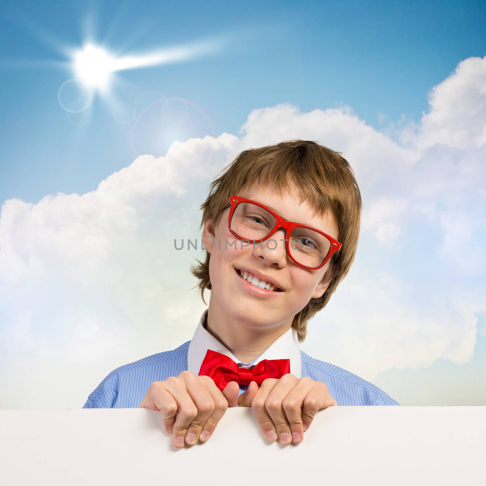 boy holding a white banner. place for text