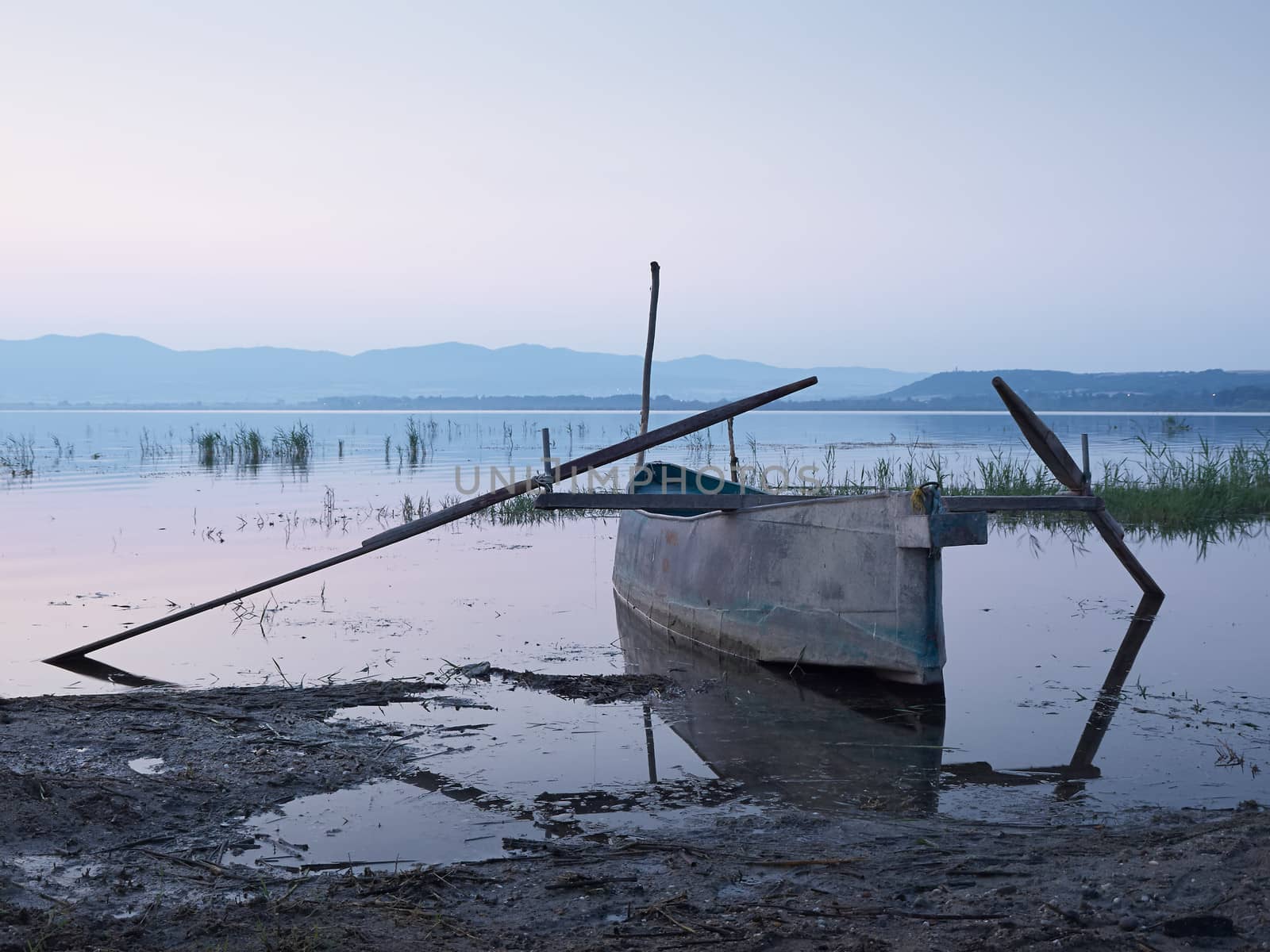 Fishing boat in the lake at dawn         