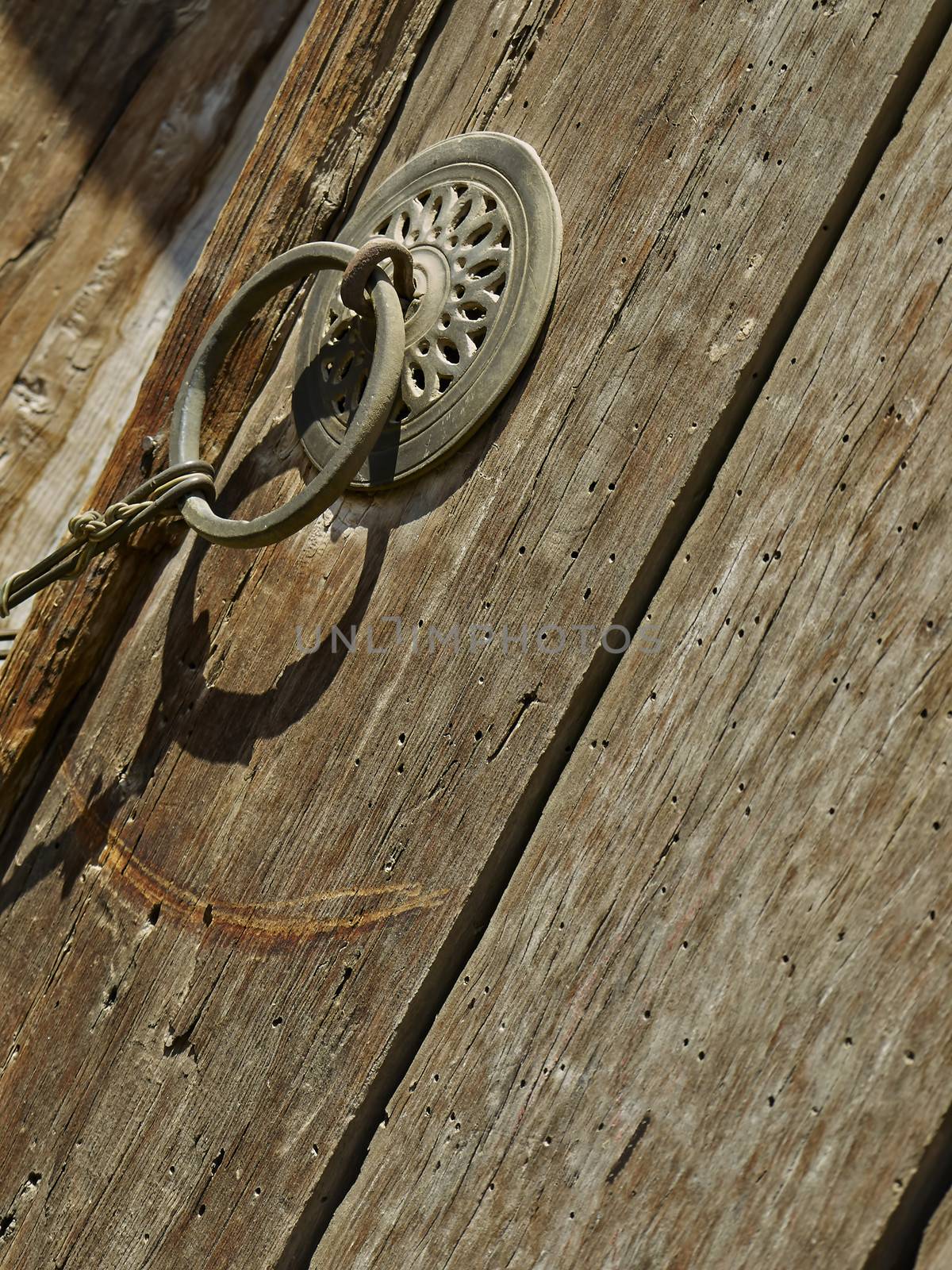 Part of an old wooden door with round handle 