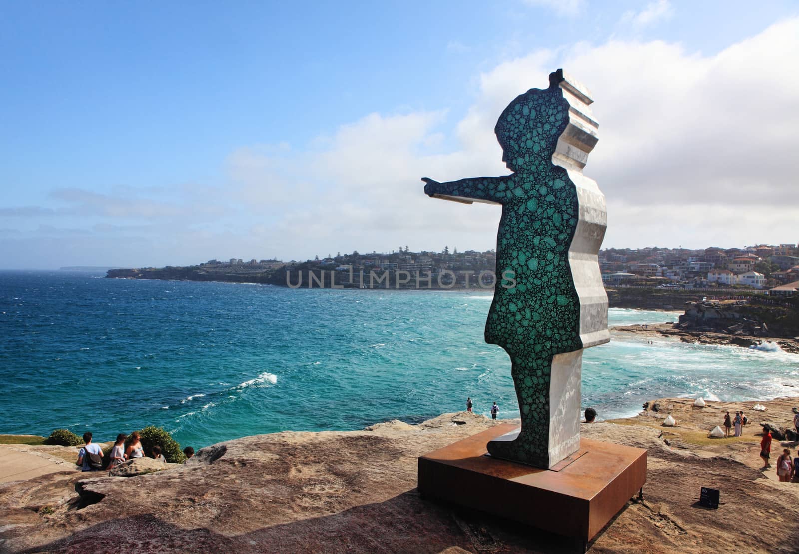 Bondi - Tamarama Beach, Australia - November 9,  2013: Sculpture By The Sea, Bondi 2013. Annual cultural event that showcases artists from around the world  Sculpture titled 'girl pointing ' by Matt Calvert (TAS).  Medium -  aluminium, grout, glass, siliconel  $68000