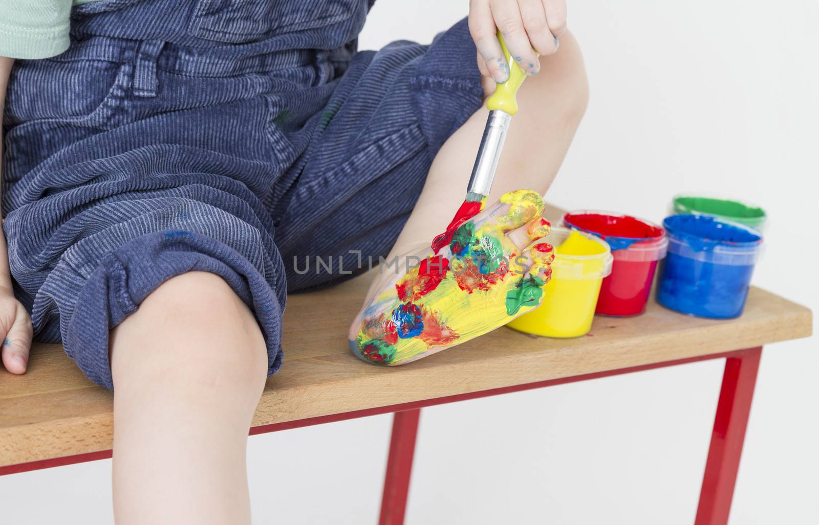 foot of child colorful painted with finger paint