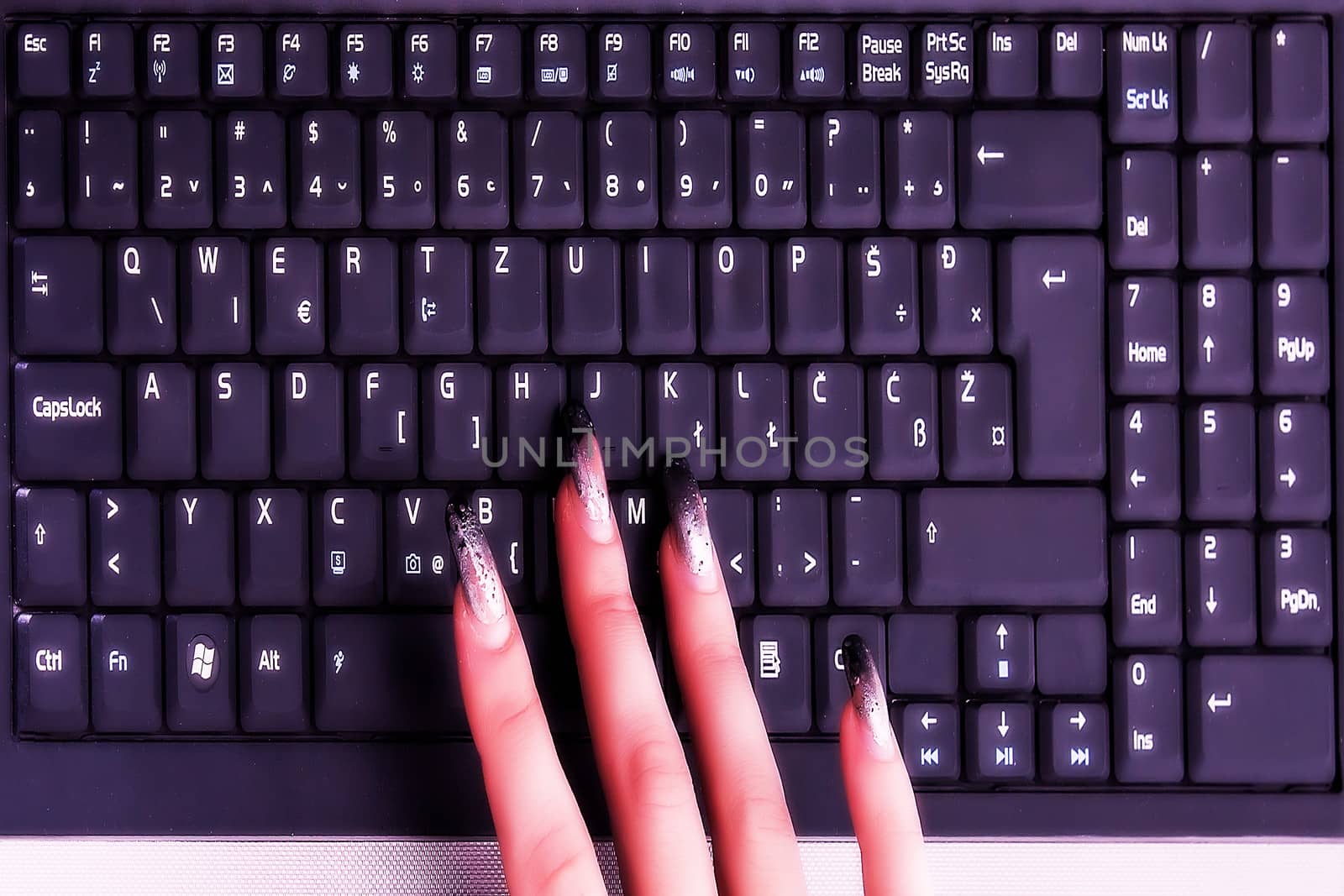 Female hand working on lap top keyboard by dukibu