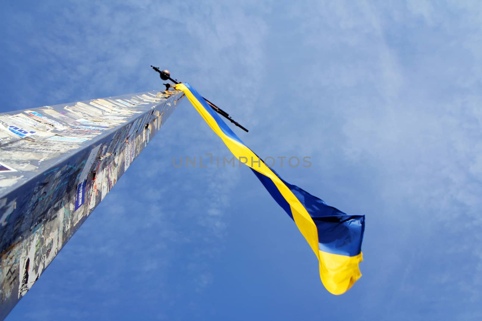 Ukrainian flag waving on blue sky background