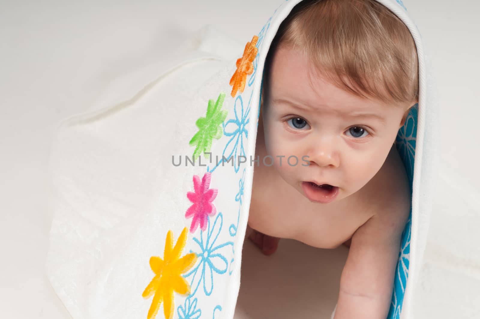 Cute aby boy in white floral towel